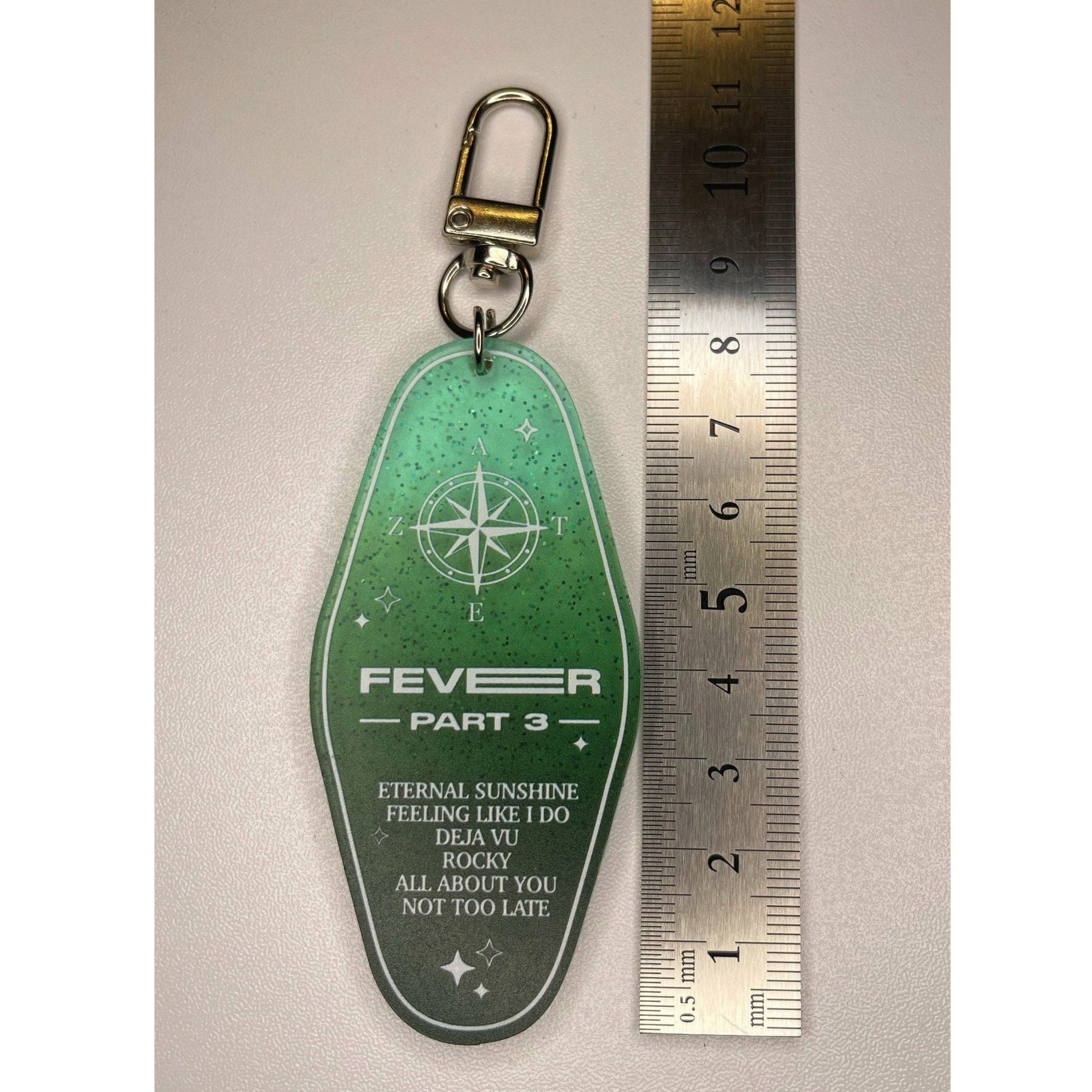 ATEEZ Fever Part 3 Keychain - MilkBunn Co. Ateez fever pt.3 keychain, A ver (green) shown next to ruler for accurate size.